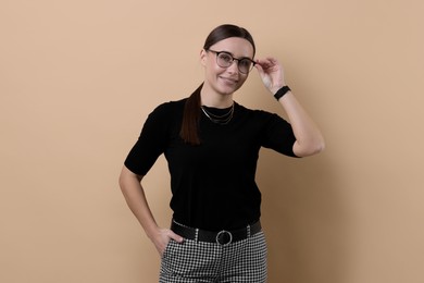 Photo of Portrait of businesswoman in glasses on beige background