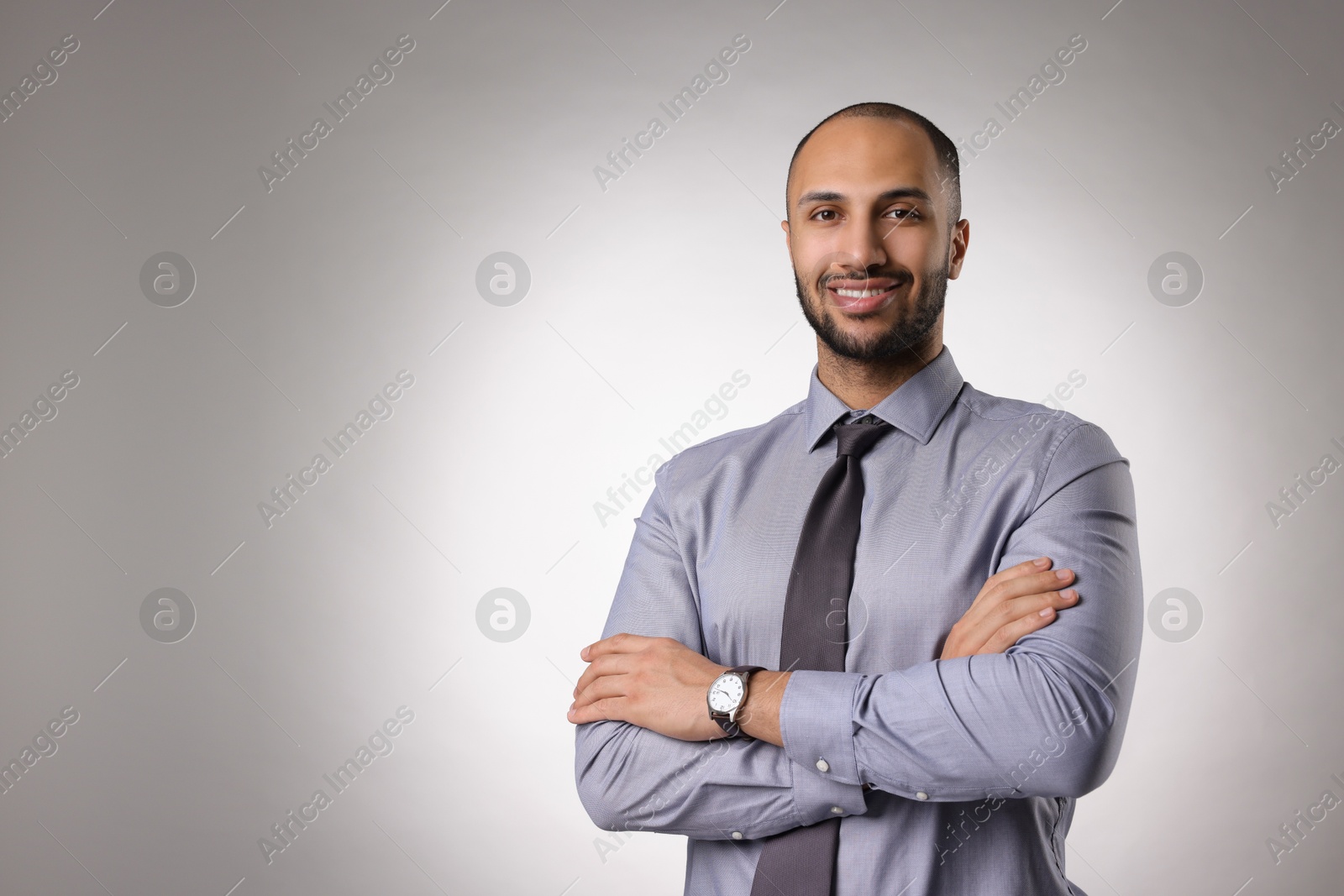 Photo of Portrait of businessman on light gray background, space for text