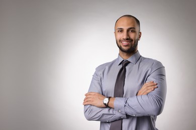 Portrait of businessman on light gray background, space for text