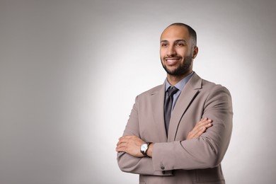 Photo of Portrait of businessman on light gray background, space for text