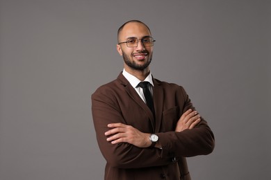 Portrait of businessman in glasses on gray background