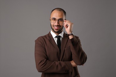 Portrait of businessman in glasses on gray background