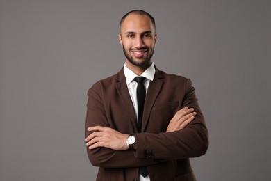 Portrait of businessman in brown jacket on gray background