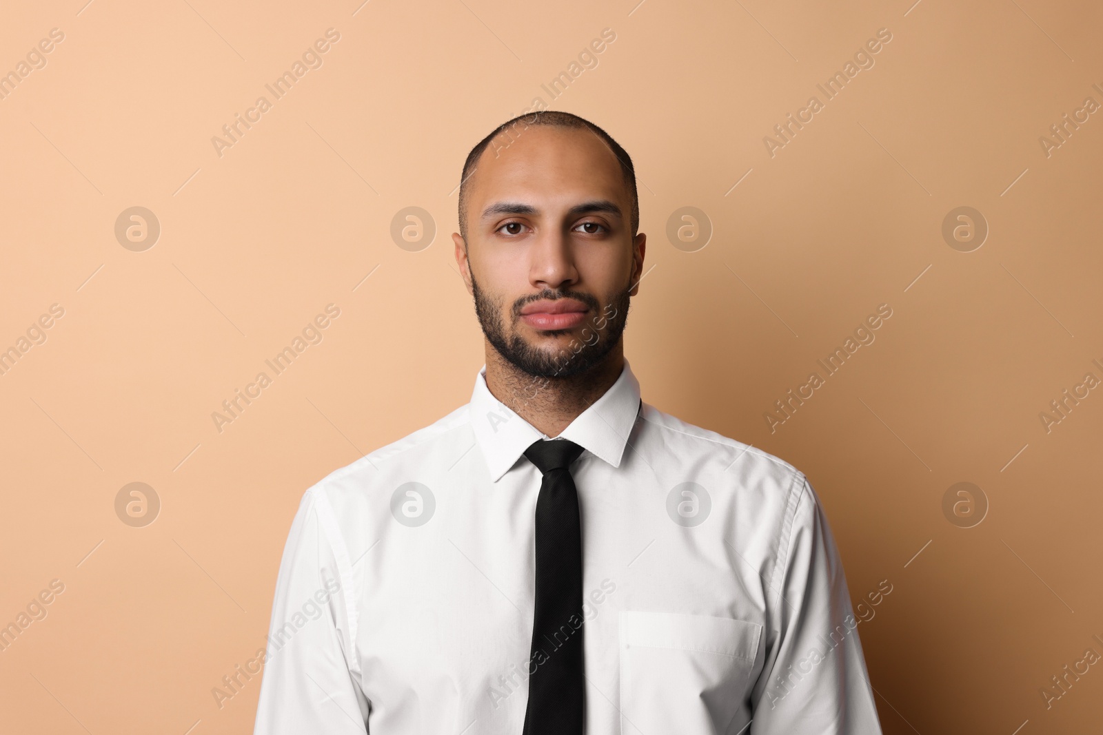 Photo of Portrait of businessman with necktie on beige background