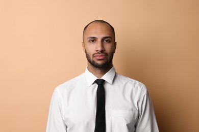 Photo of Portrait of businessman with necktie on beige background