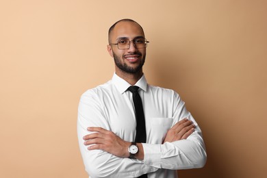 Portrait of businessman in glasses on beige background