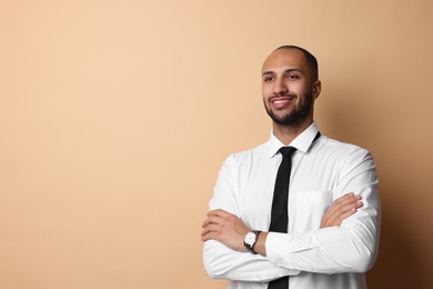 Portrait of businessman on beige background, space for text