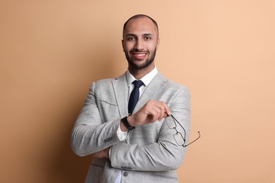 Photo of Portrait of businessman with glasses on beige background