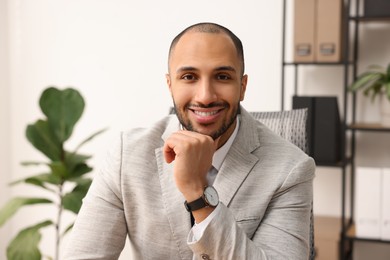 Photo of Portrait of happy businessman in jacket indoors