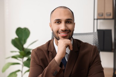 Photo of Portrait of happy businessman in jacket indoors