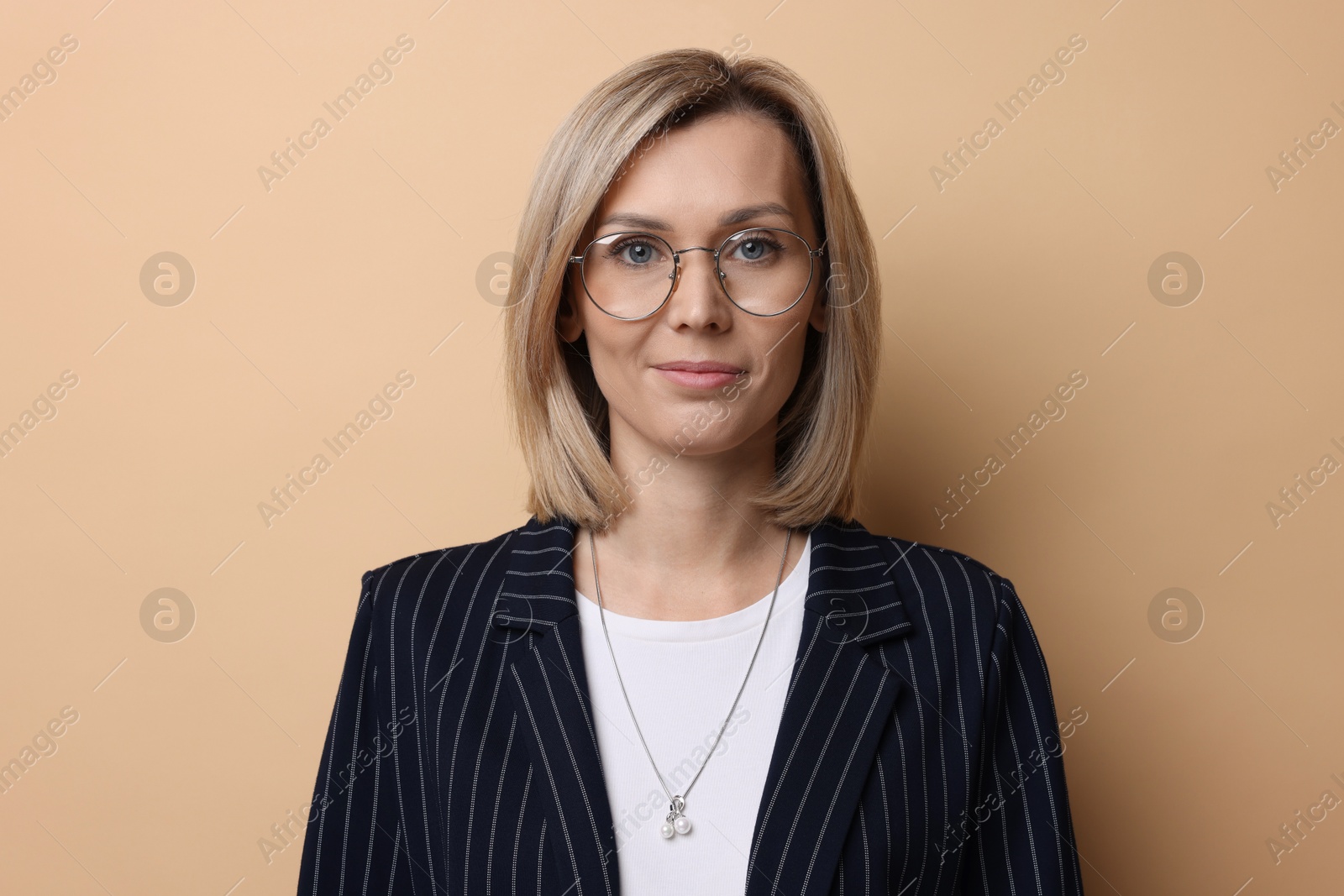 Photo of Portrait of businesswoman in glasses on beige background