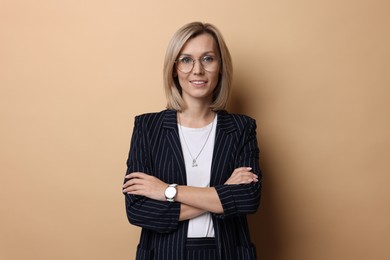 Photo of Portrait of businesswoman in glasses on beige background