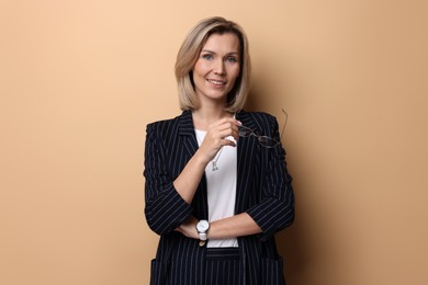 Photo of Portrait of businesswoman with glasses on beige background