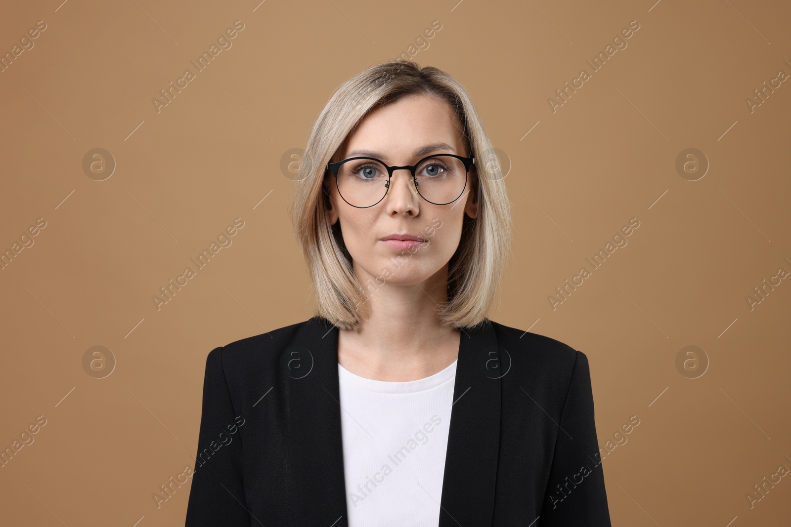 Photo of Portrait of businesswoman in glasses on beige background