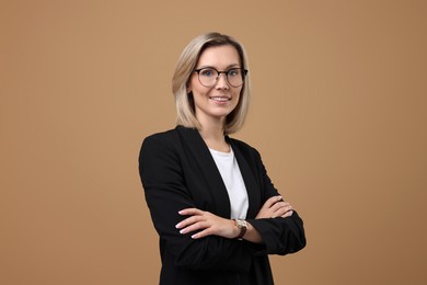 Photo of Portrait of businesswoman in glasses on beige background