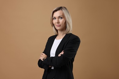 Photo of Portrait of businesswoman in jacket on beige background