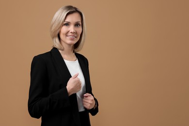 Photo of Portrait of businesswoman on beige background, space for text