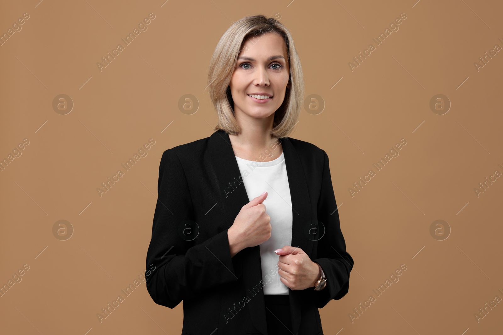 Photo of Portrait of businesswoman in jacket on beige background