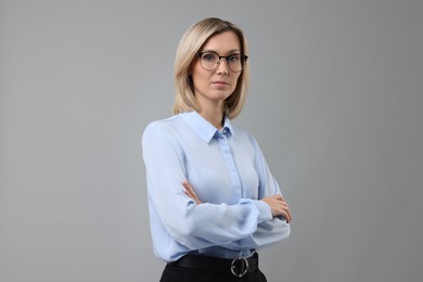 Photo of Portrait of businesswoman in glasses on gray background