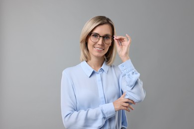 Photo of Portrait of businesswoman in glasses on gray background