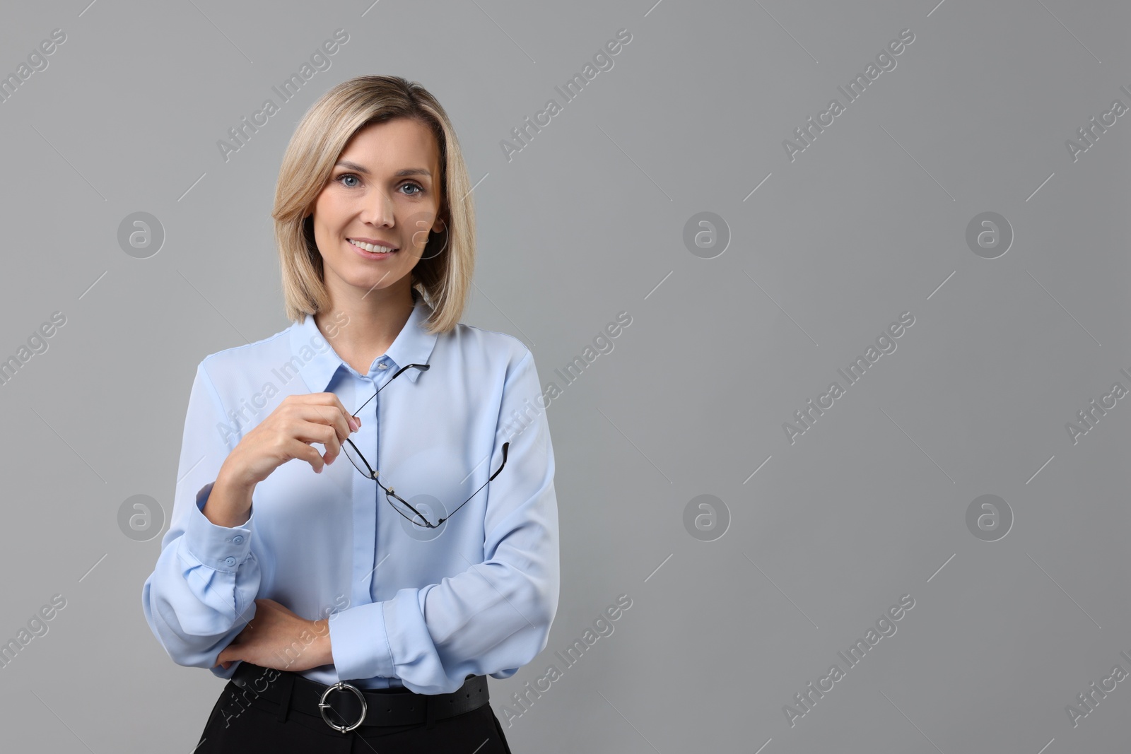 Photo of Portrait of businesswoman with glasses on gray background, space for text