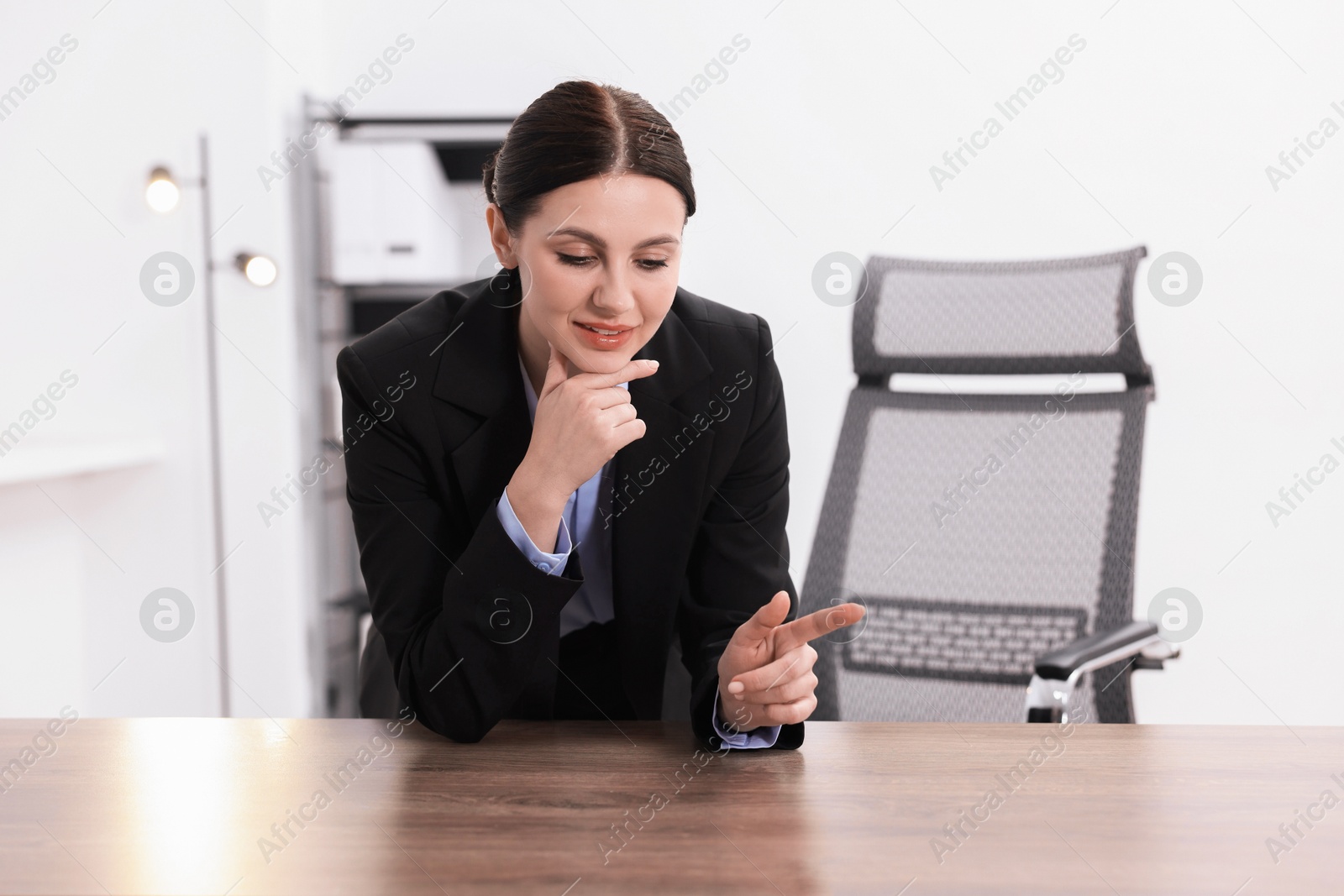 Photo of Beautiful woman looking at something in office