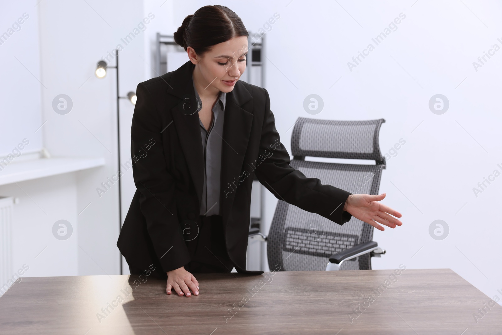 Photo of Beautiful woman looking at something in office