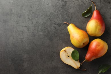 Photo of Ripe juicy pears on grey table, flat lay. Space for text