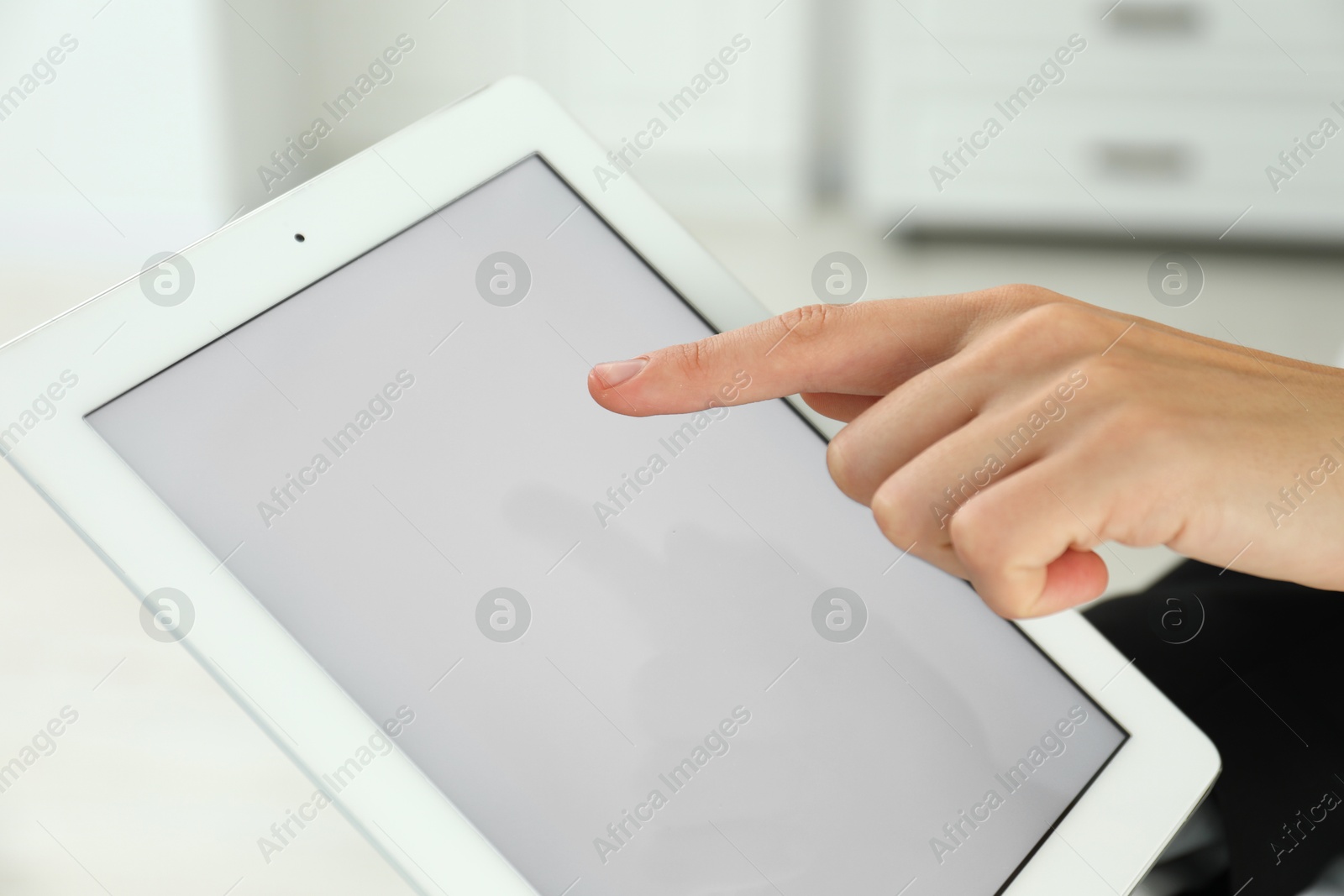 Photo of Businesswoman using tablet indoors, closeup. Modern technology