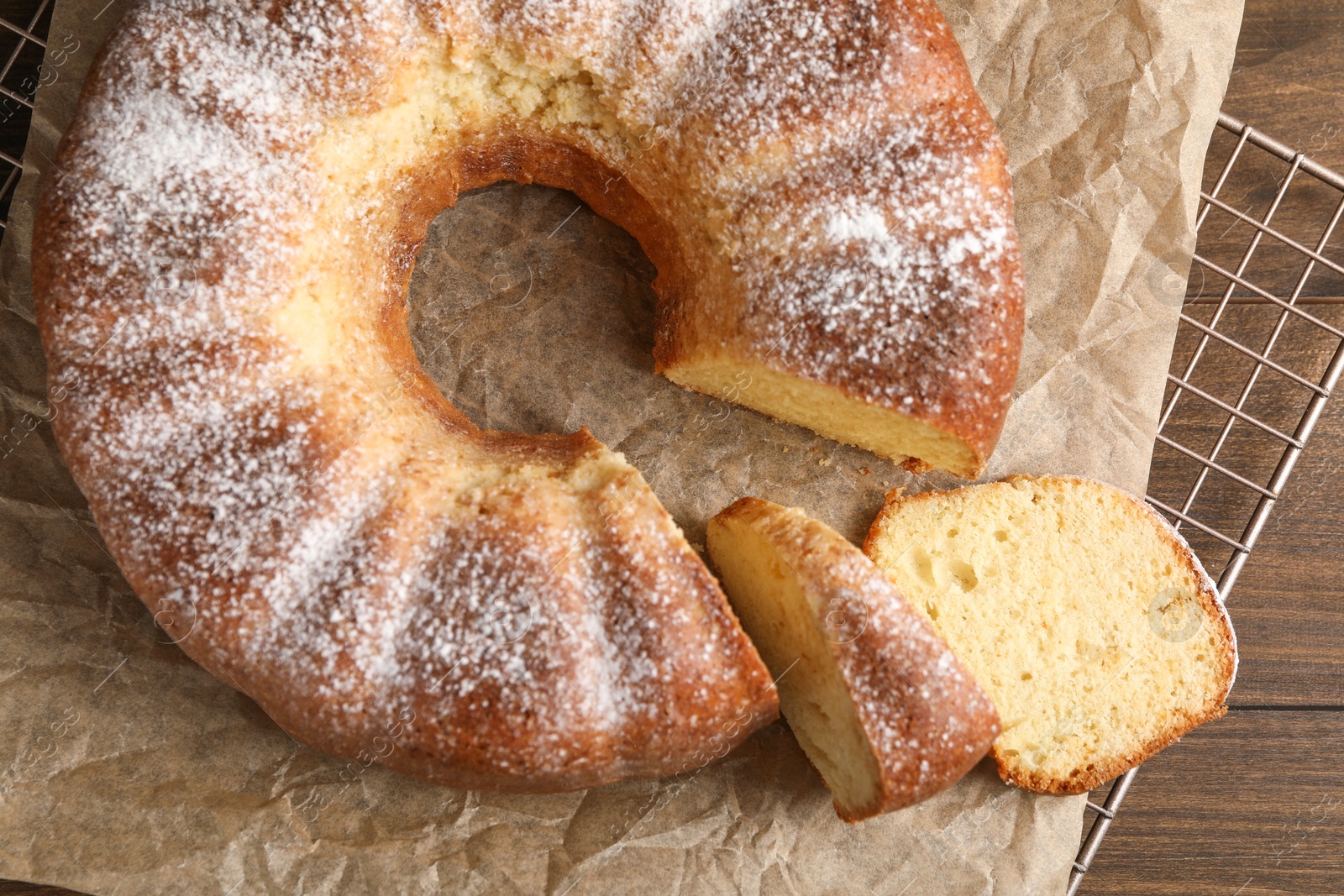 Photo of Freshly baked sponge cake on wooden table, top view