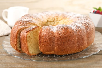 Photo of Freshly baked sponge cake on wooden table, closeup