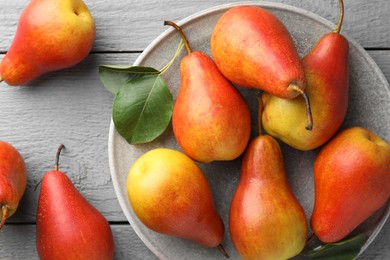 Photo of Ripe juicy pears on grey wooden table, flat lay