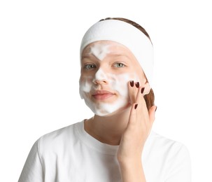 Photo of Teenage girl washing her face with cleanser on white background. Cosmetic product