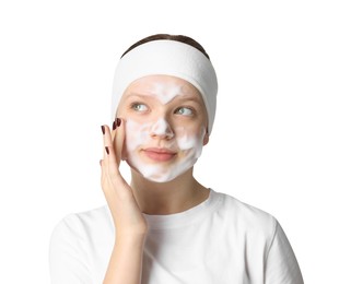 Photo of Teenage girl washing her face with cleanser on white background. Cosmetic product