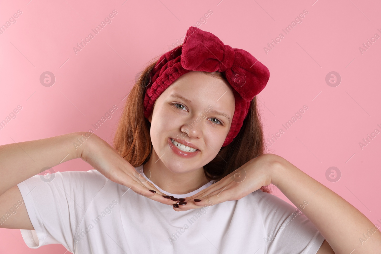 Photo of Portrait of teenage girl with headband on pink background