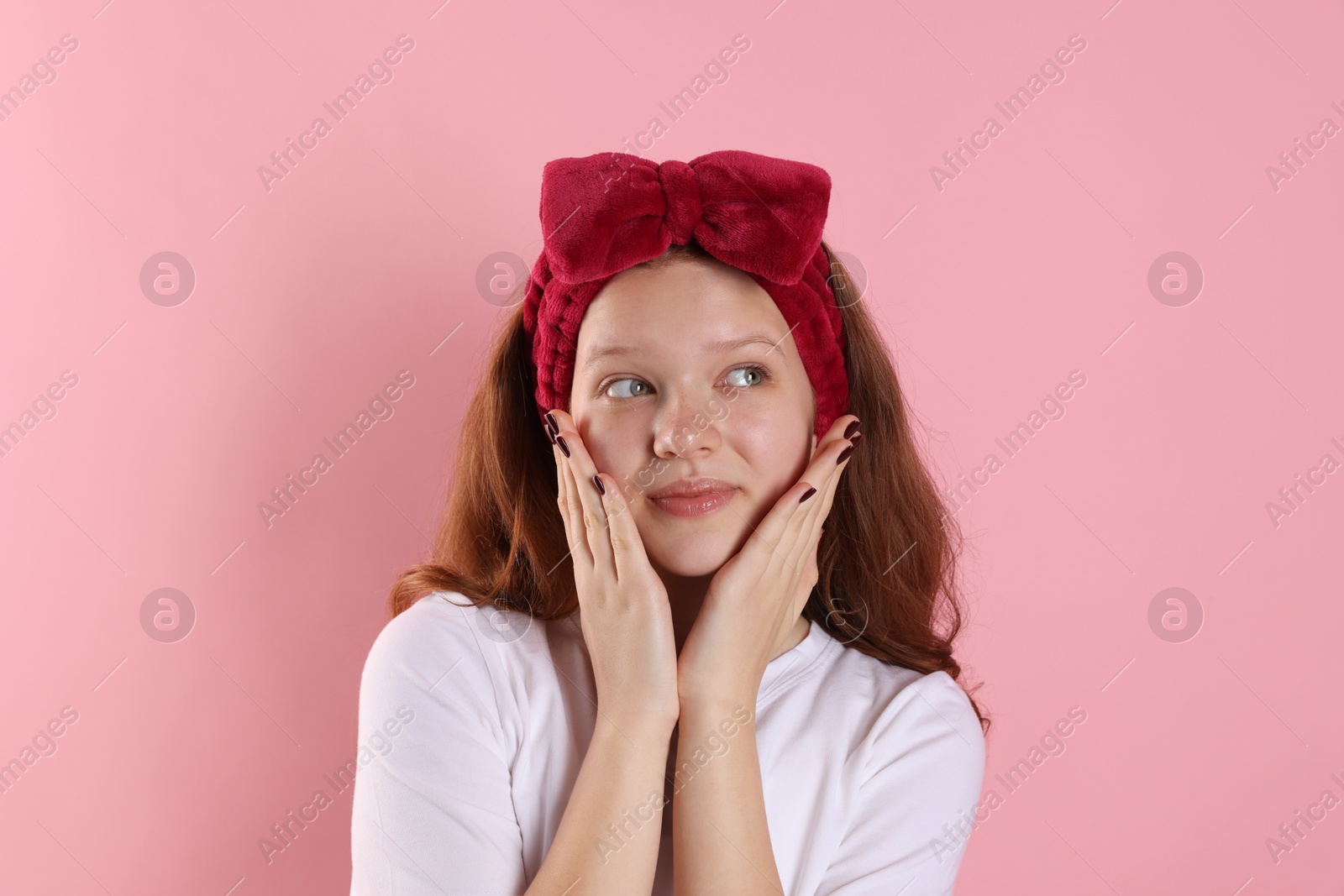 Photo of Portrait of teenage girl with headband on pink background