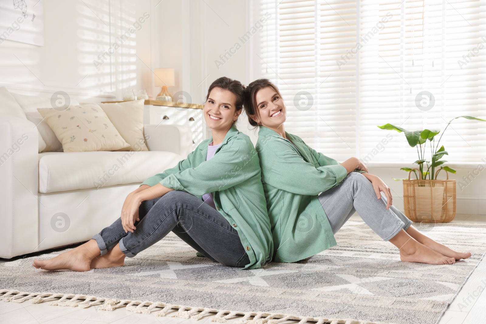 Photo of Portrait of beautiful twin sisters at home