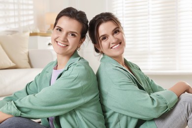 Photo of Portrait of beautiful twin sisters at home