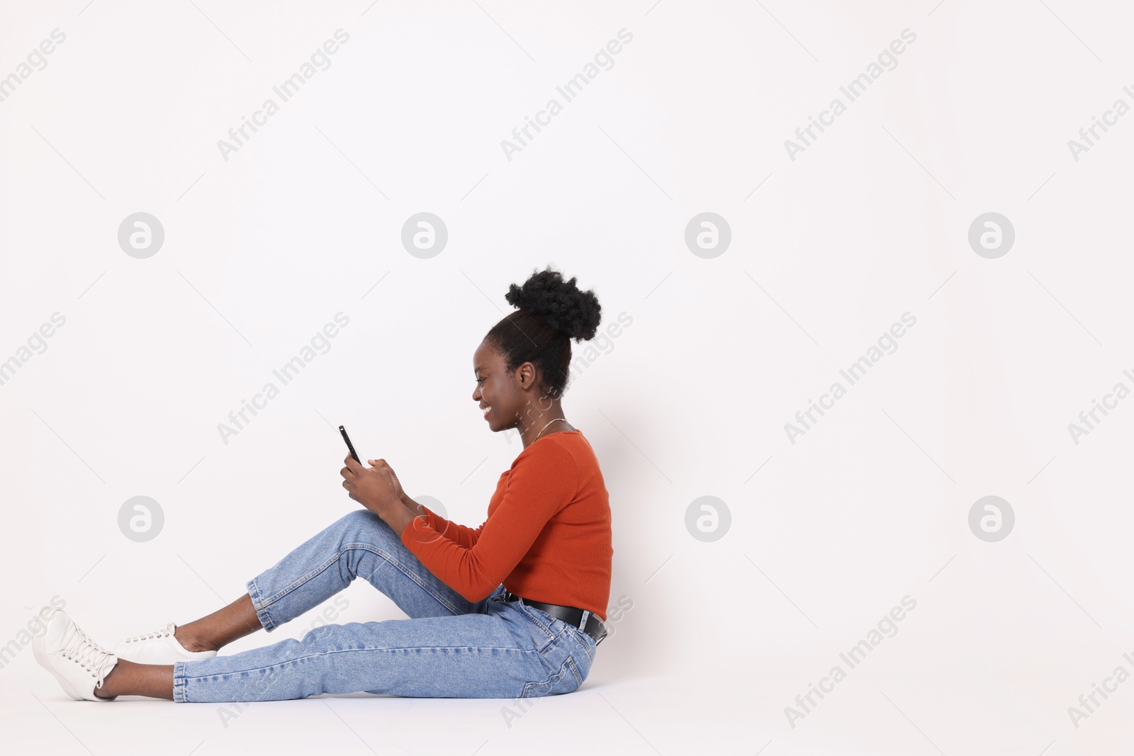 Photo of Happy woman with smartphone on white background. Space for text