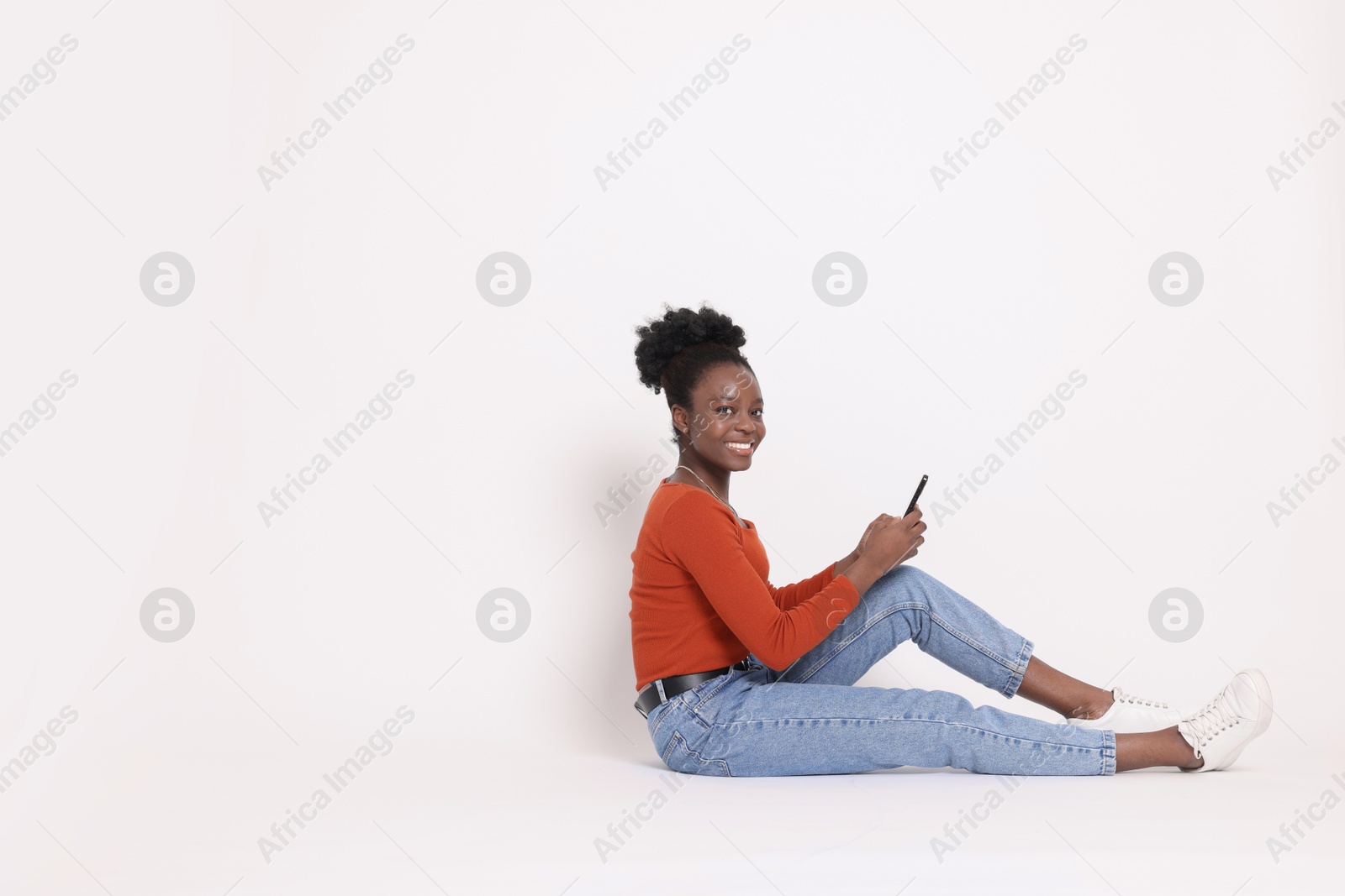 Photo of Happy woman with smartphone on white background. Space for text