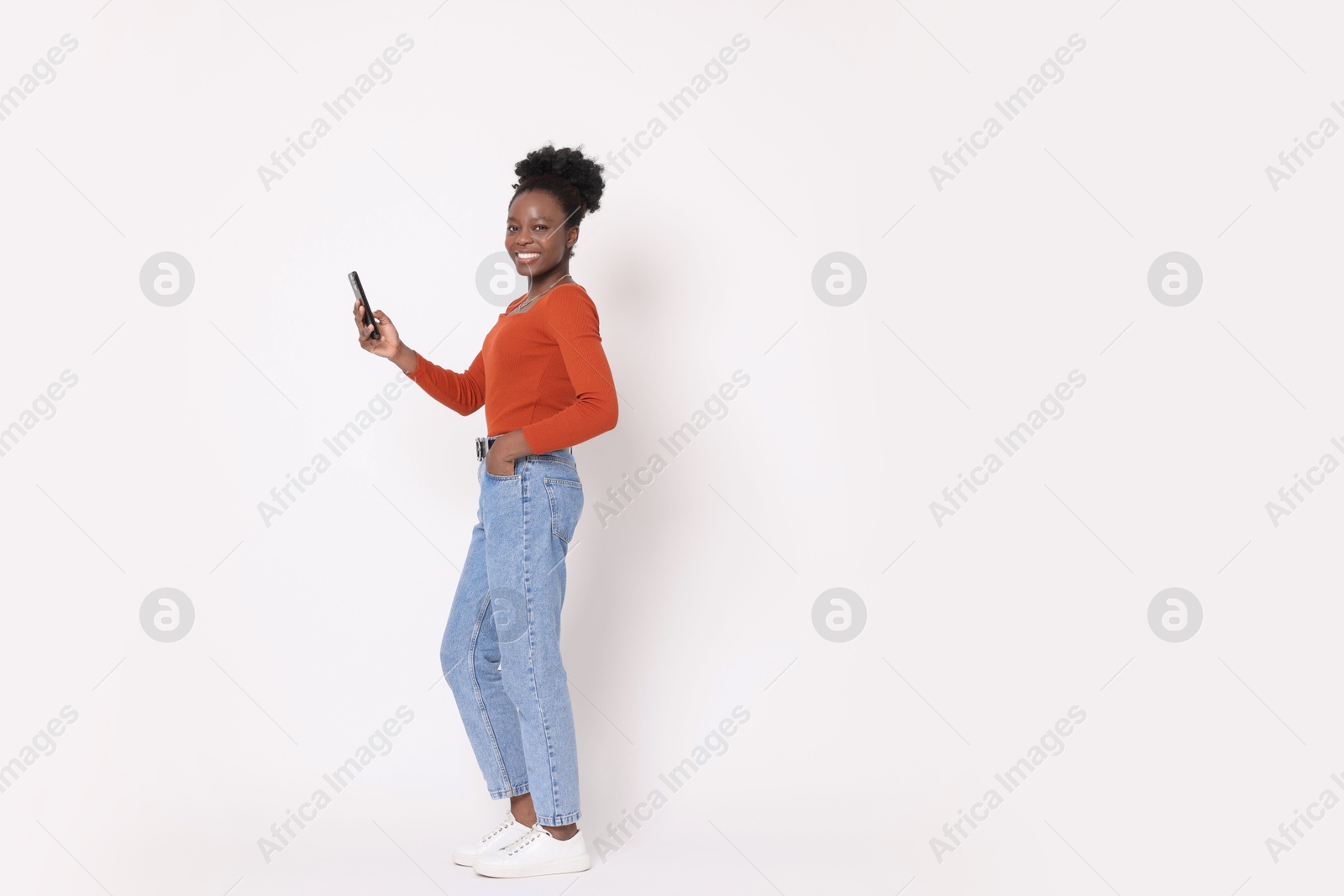 Photo of Happy woman with smartphone on white background. Space for text