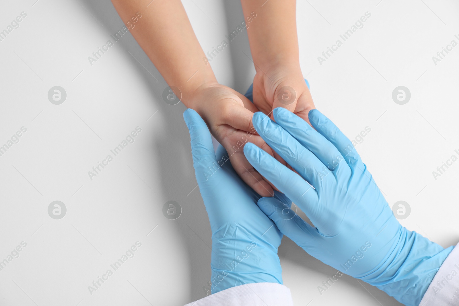 Photo of Doctor and child on white background, top view