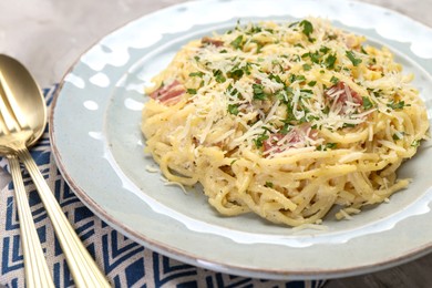 Photo of Delicious pasta Carbonara with bacon served on gray table, closeup