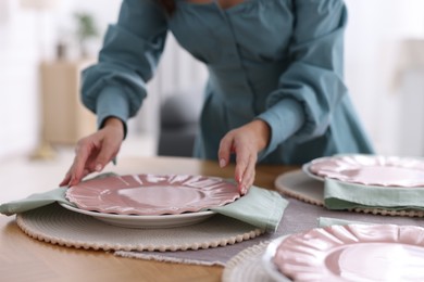 Photo of Woman setting table for dinner at home, closeup