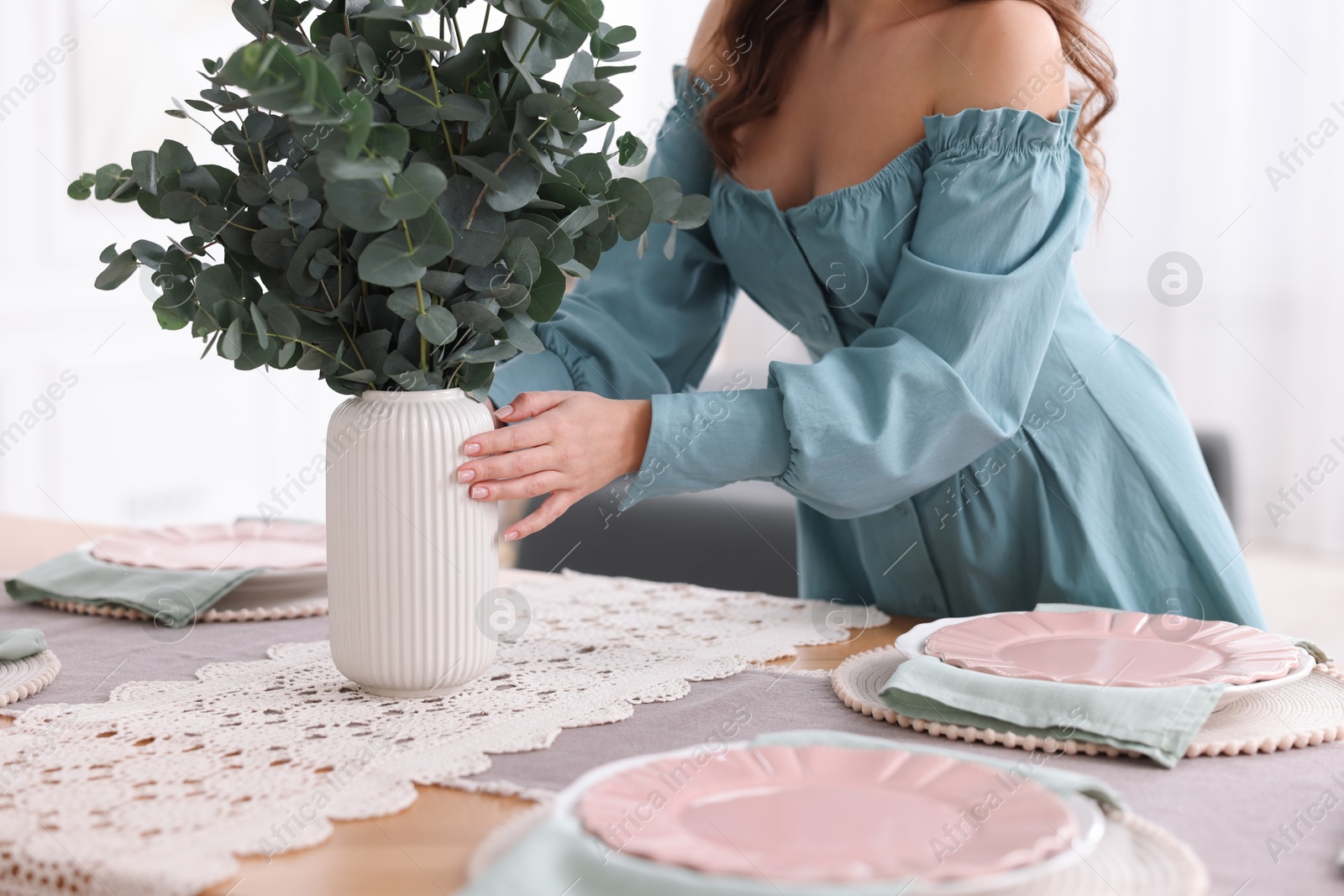 Photo of Woman setting table for dinner at home, closeup