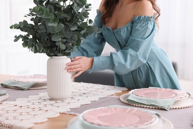 Photo of Woman setting table for dinner at home, closeup