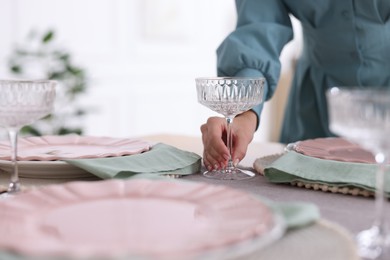 Photo of Woman setting table for dinner at home, closeup