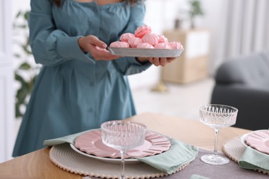 Photo of Woman setting table for dinner at home, closeup