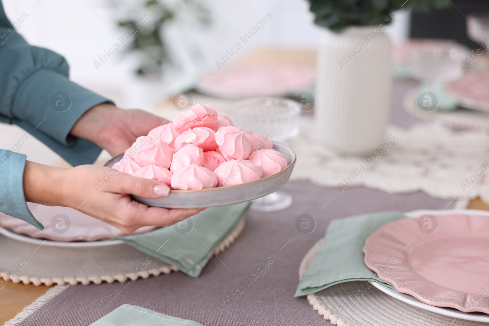 Photo of Woman setting table for dinner at home, closeup