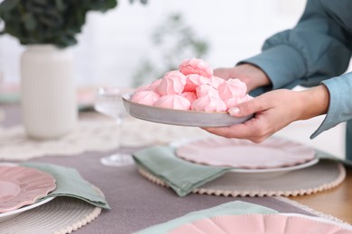 Photo of Woman setting table for dinner at home, closeup